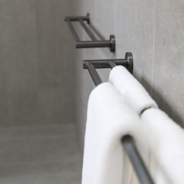 White towel hanging on a modern black towel rack.