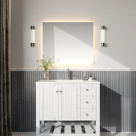 Modern bathroom with illuminated mirror, white vanity, and wall sconces.