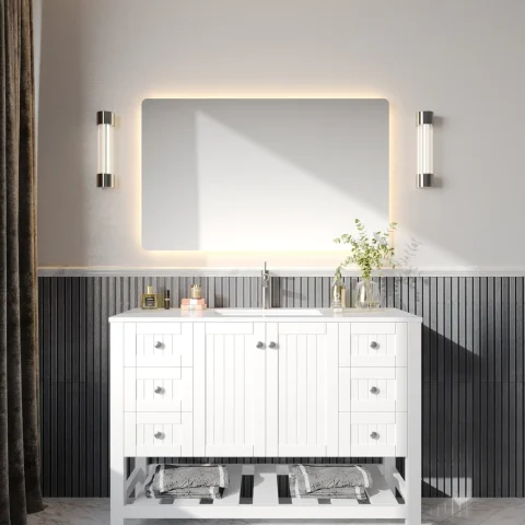 Modern bathroom with illuminated mirror, white vanity, and decorative lighting.