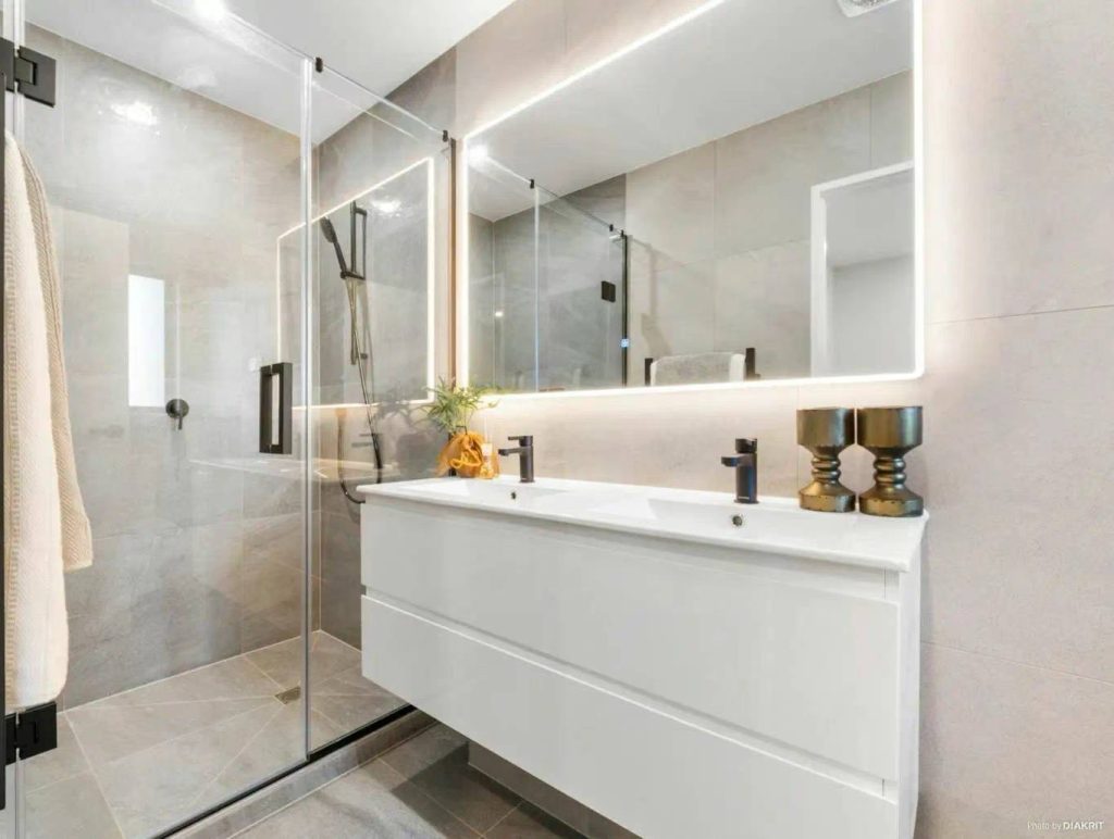 LMF 1500X800 Modern bathroom with glass shower, illuminated mirror, and white vanity.