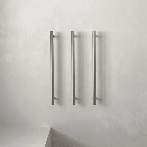 Three vertical metal towel bars on a light gray wall.