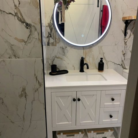 white coloured vanity with black taps