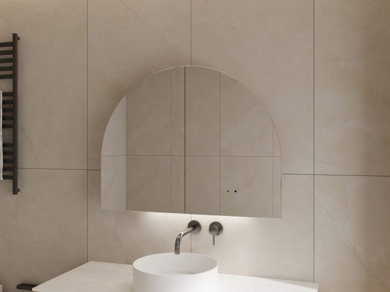 Arched mirror above a white sink with wall-mounted faucet.