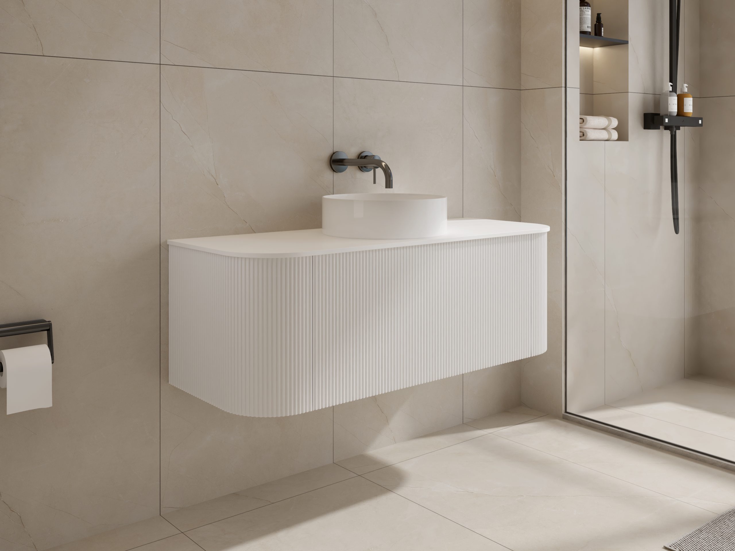 Modern white bathroom sink with wall-mounted faucet and beige tiled walls.
