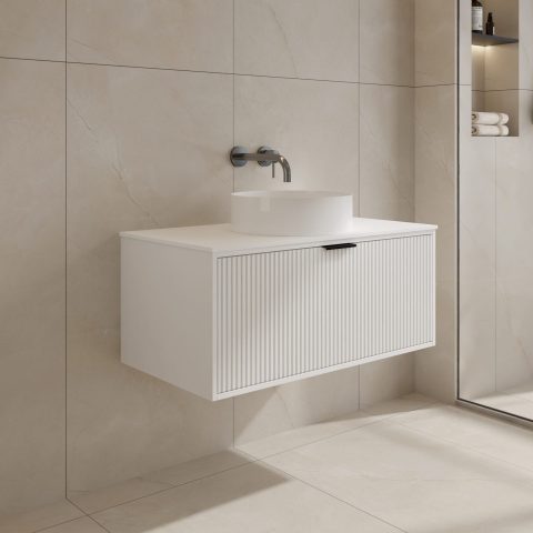 Modern white bathroom vanity with wall-mounted faucet and mirror.