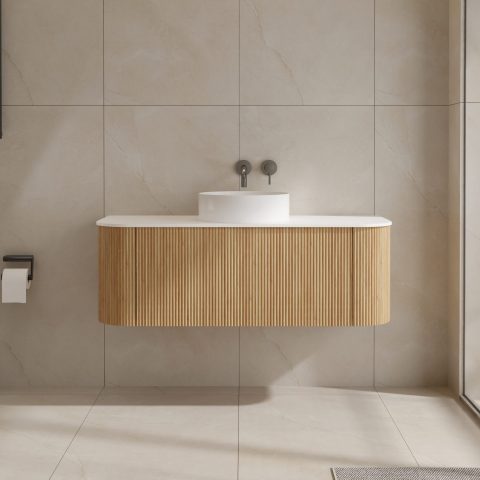 Modern bathroom with wooden vanity and white sink.