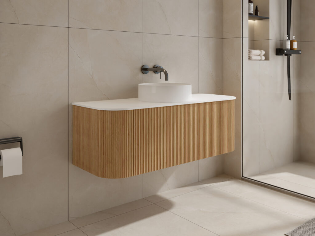 Modern bathroom with wooden vanity, white sink, and glass shower enclosure.