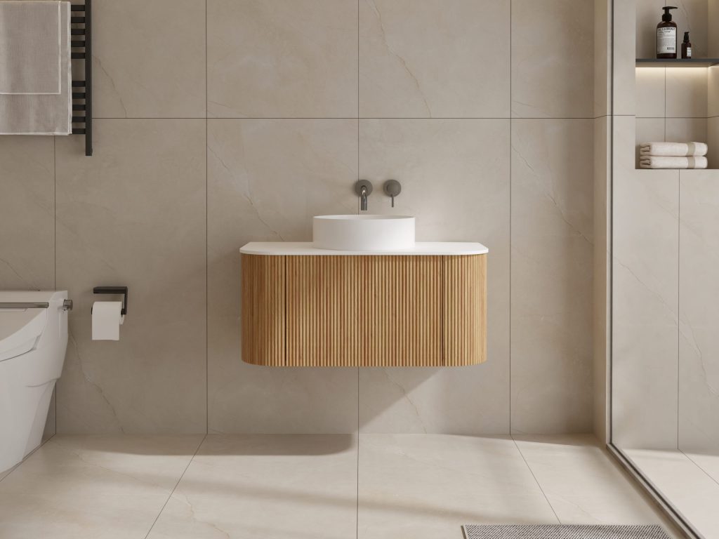 Modern bathroom with a wooden vanity and round white sink.