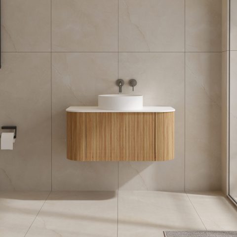 Modern bathroom with a wooden vanity and round white sink.