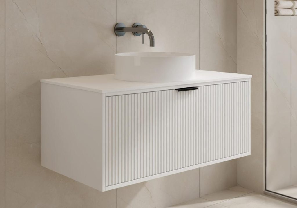 Modern white bathroom vanity with round sink and wall-mounted faucet.