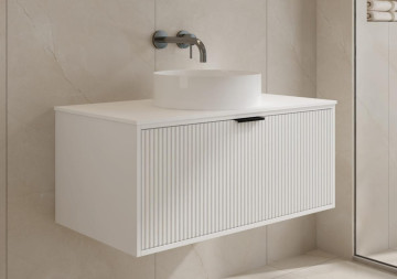 Modern white bathroom vanity with round sink and wall-mounted faucet.