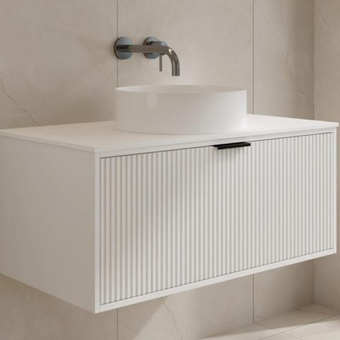 Modern white bathroom vanity with round sink and wall-mounted faucet.