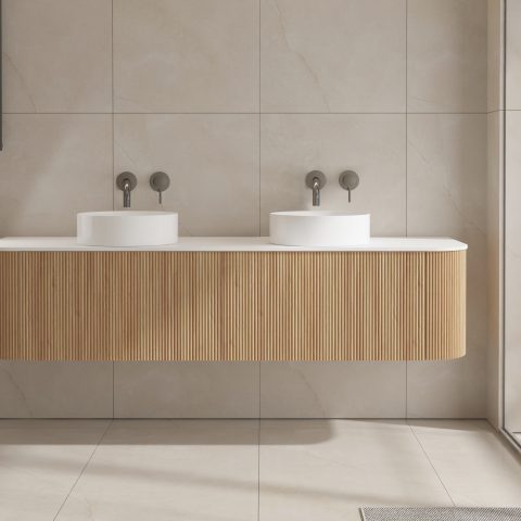 Modern bathroom with double sinks and wooden vanity.