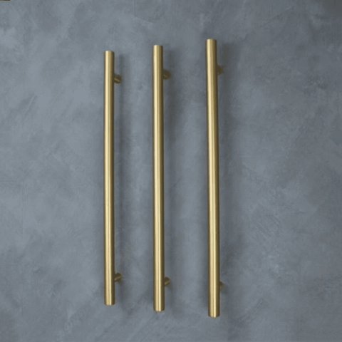Three vertical gold handles on a gray textured background.