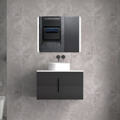 Modern bathroom with black vanity, round sink, and wall-mounted mirror.