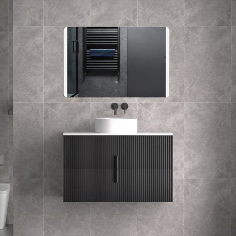 Modern bathroom with wall-mounted sink, mirror, and gray tiled walls.