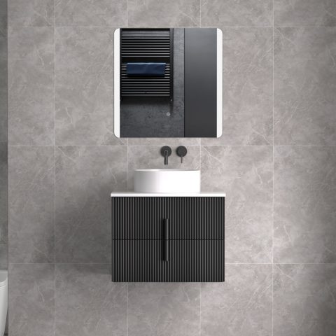 Modern bathroom vanity with black cabinet and round white sink.