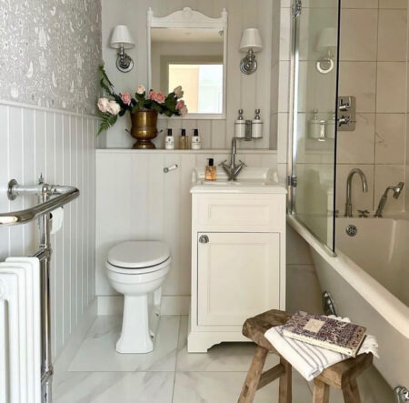 A classic light bathroom with a bath tub